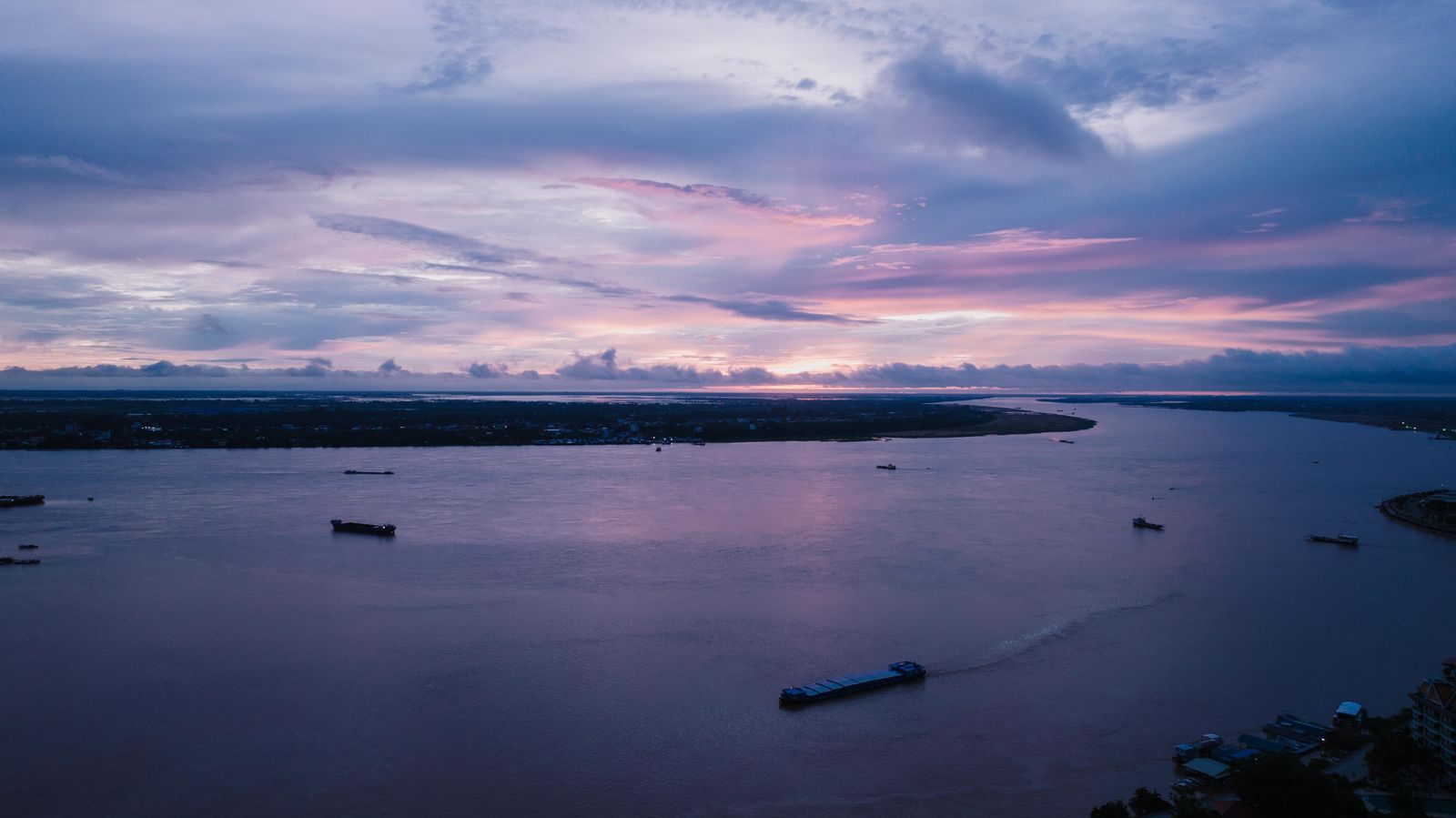 Wide river at dusk near Phnom Penh, Cambodia, the stretch a Vietnam Cambodia river cruise follows upstream